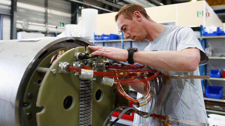 worker installing magnets large hadron collider