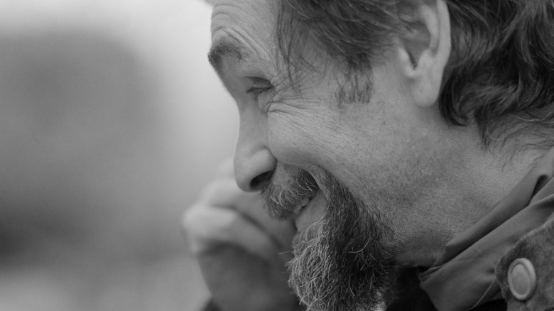 side profile Charles Manson smiling