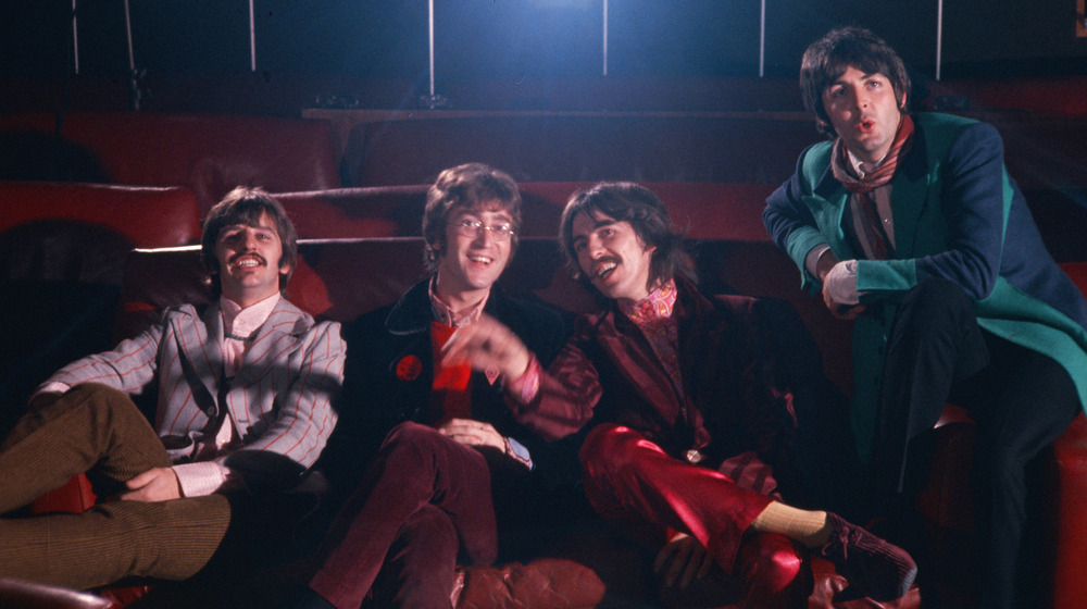 The Beatles sitting in a theater