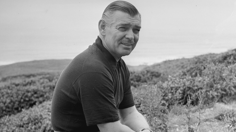 Clark Gable seated and posing