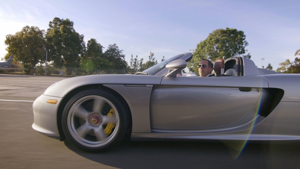 Jerry Seinfeld in a silver car