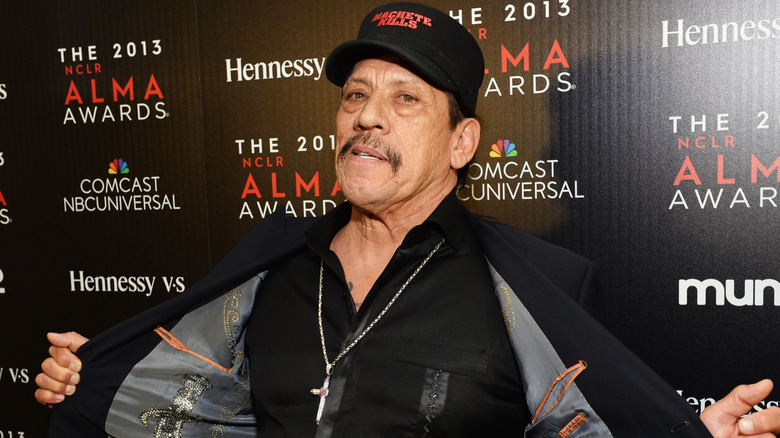 Danny Trejo holding jacket open