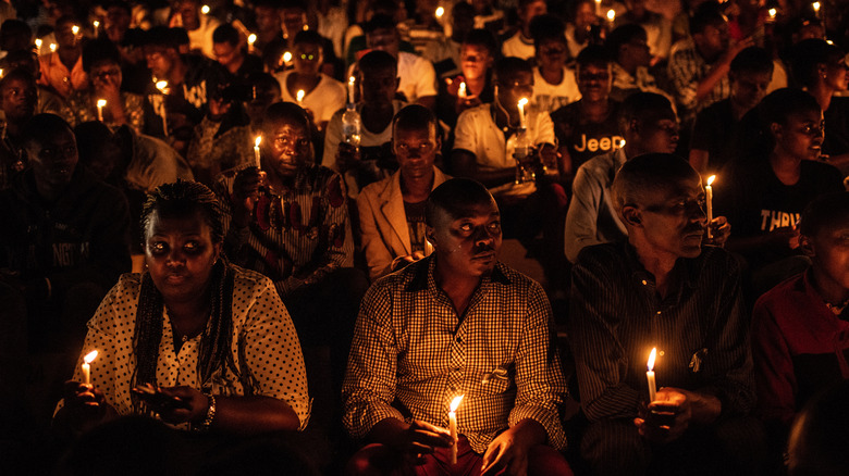 people holding candles memorial