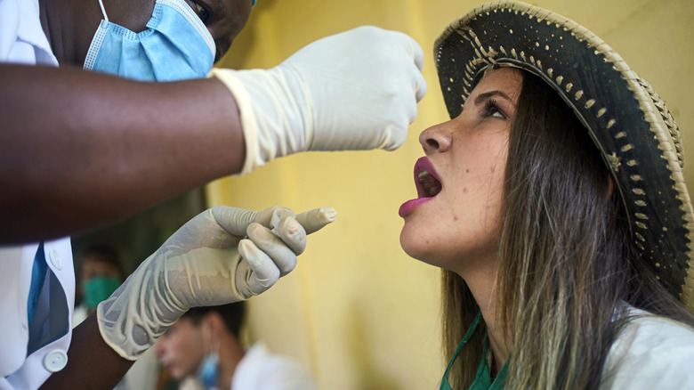 woman receiving homeopathic medicine