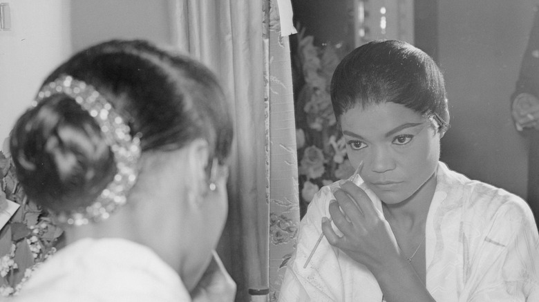 Earth Kitt putting on makeup in her dressing room, 1950s