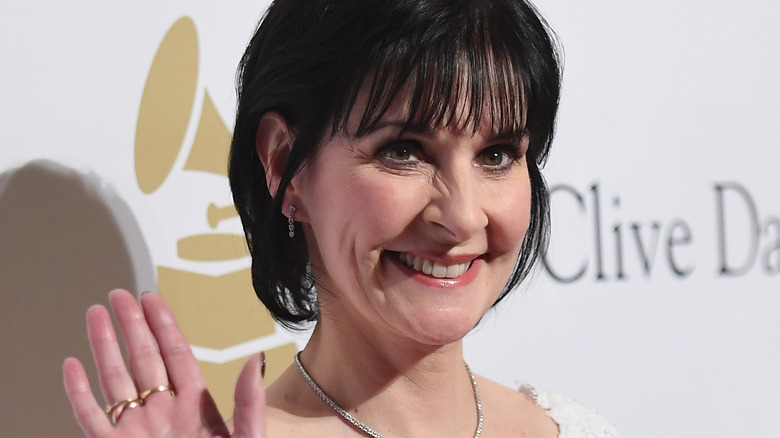 Enya grinning waving