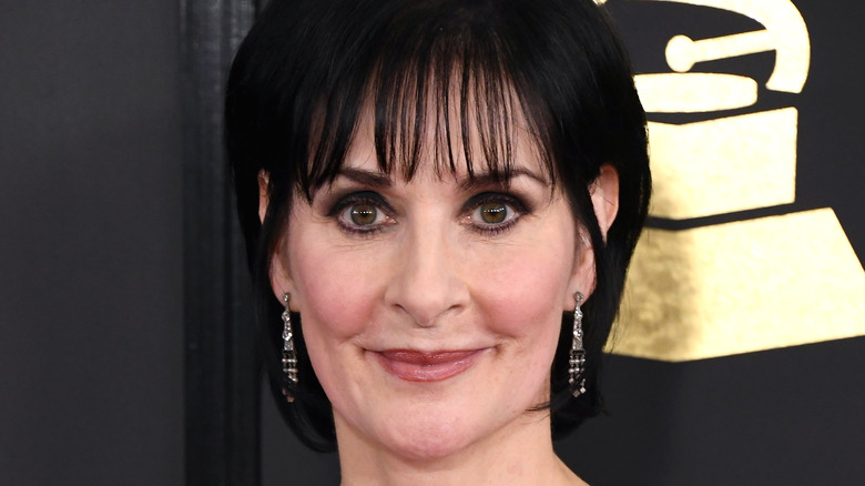 Enya smiling dangly earrings at Grammys