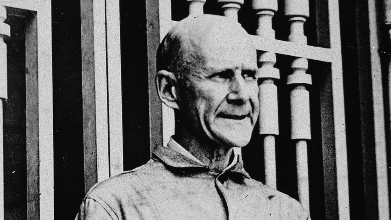 Eugene V. Debs in front of bars