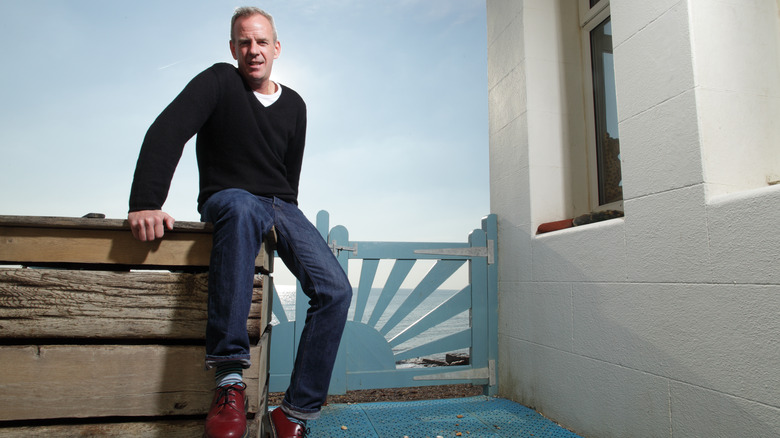 Fatboy Slim sits on wall at Brighton Beach