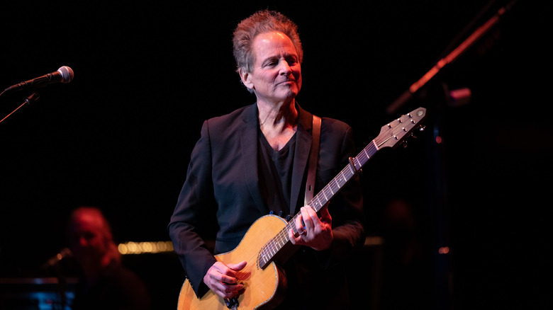 Lindsey Buckingham playing guitar on stage