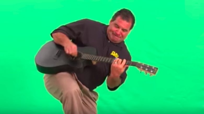 Phil Swift playing guitar