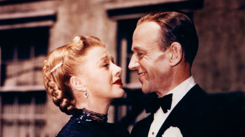 Ginger Rogers and Fred Astaire smiling at each other
