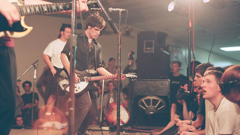 Guy Picciotto on stage and fans in audience