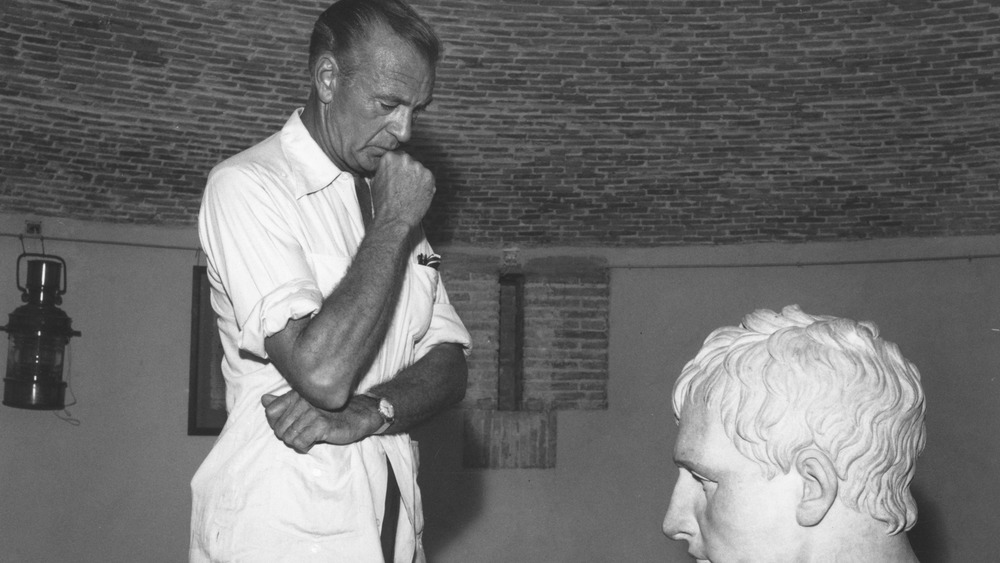 Gary Cooper looking at a bust of Napoleon