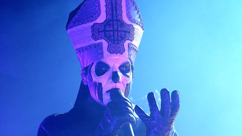 ghost singer wearing mitre blue light