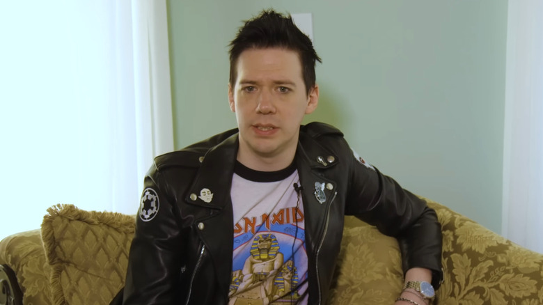 Tobias Forge black leather jacket sat on couch