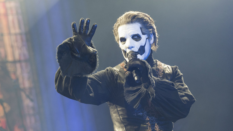 Tobias Forge face paint arm raised on stage