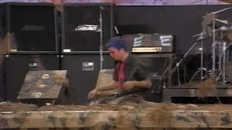 Billie Joe on stage covered in mud