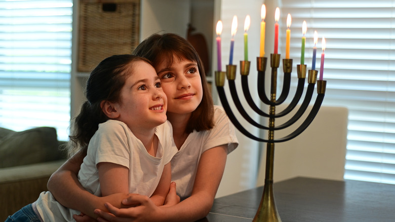 Children admire a menorah