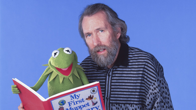 Jim Henson and Kermit the Frog reading a book