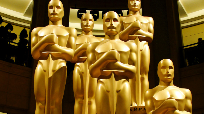 geles, California, Unites States- February 27, 2011: Five Oscar statues stand guard awaiting the Academy Awards ceremonies.