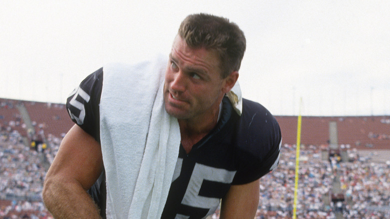 Howie Long resting on the sideline