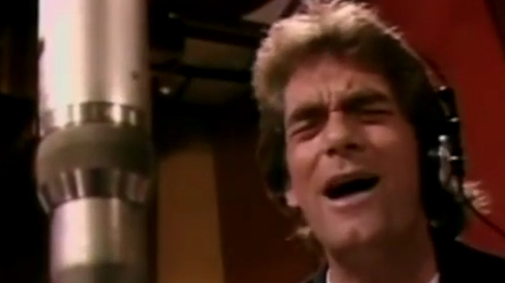 Huey Lewis singing in "We Are the World" video