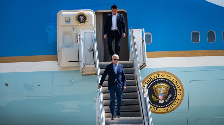 President Joe Biden descends the steps from Air Force On