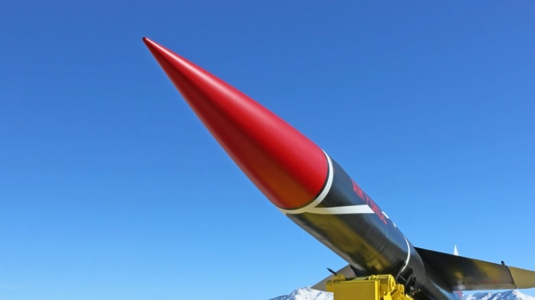 red missile tip under blue sky