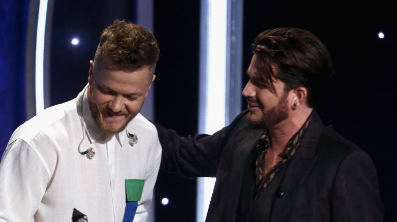 Dan Reynolds accepts a documentary award from Adam Lambert
