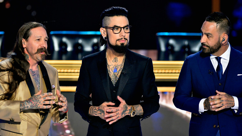 Oliver Peck standing with Ink Master judges