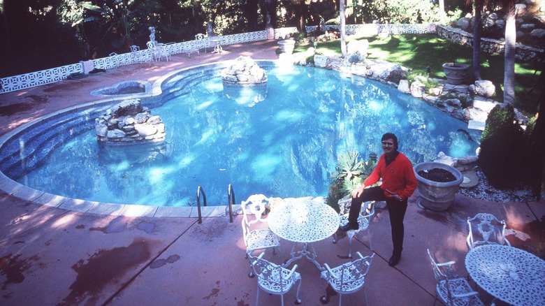 Pool at the Pink Palace with man posing