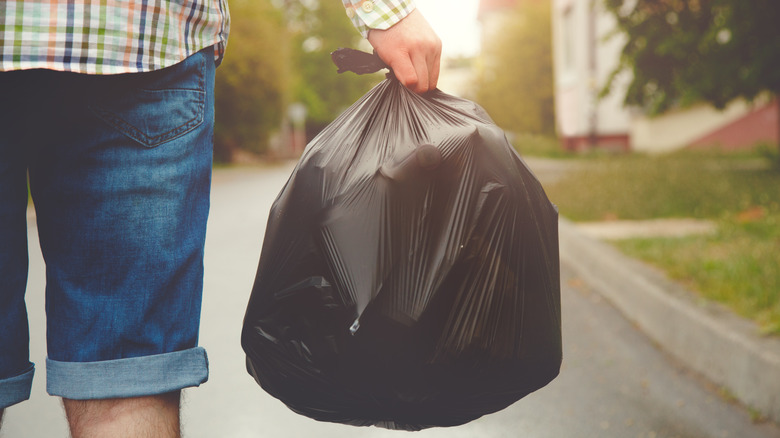 person holding garbage bag