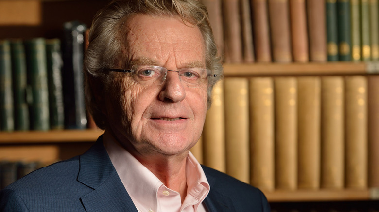 Jerry Springer in front of a bookcase