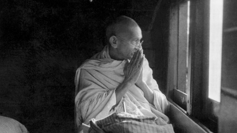 Gandhi greeting followers from train