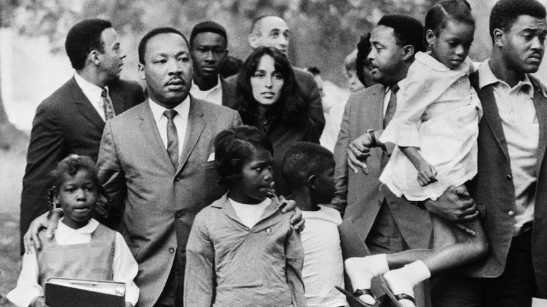 Joan Baez and Martin Luther King Jr with a group of kids