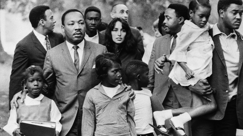 Joan Baez and Martin Luther King Jr with a group of kids