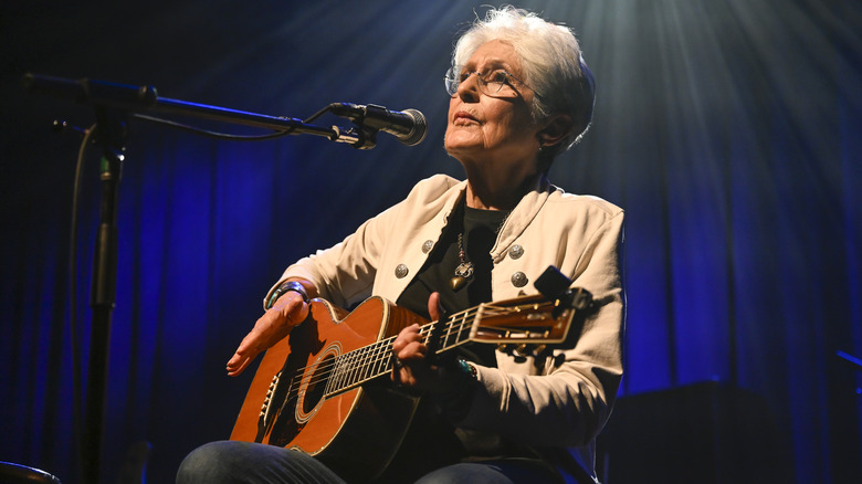 Joan Baez on stage with guitar