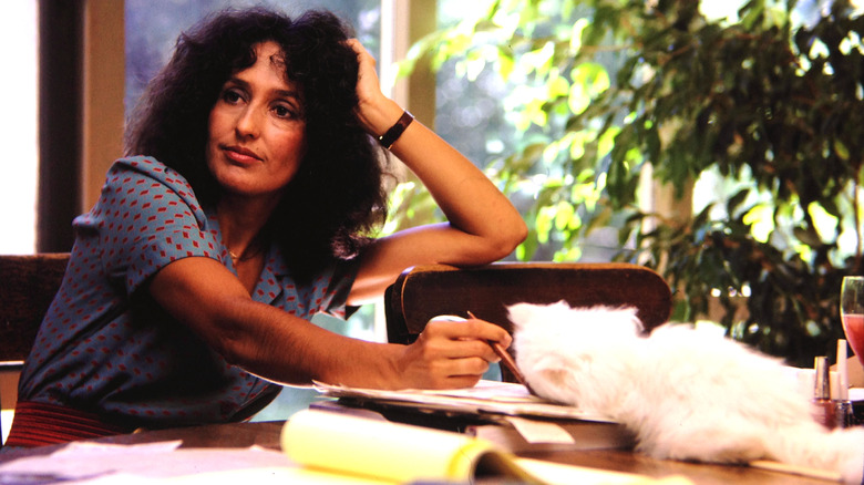 Joan Baez sitting at a table