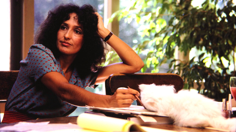 Joan Baez sitting at a table