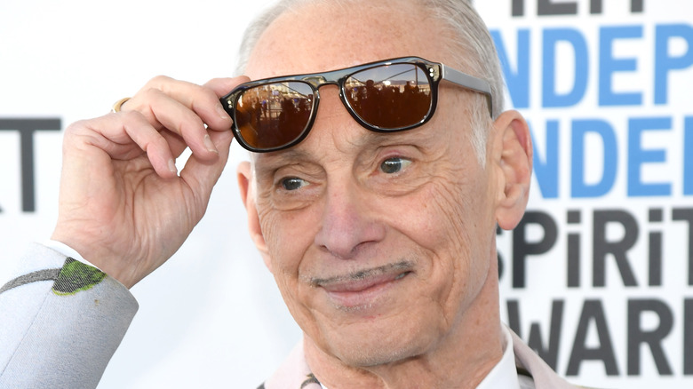 John Waters lifts sunglasses