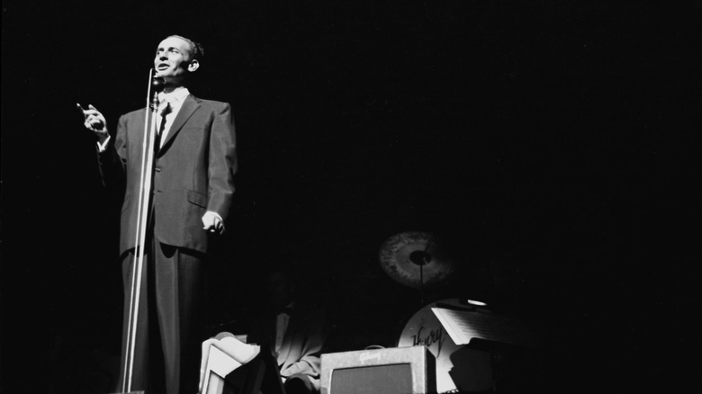 Joey Bishop performs on stage