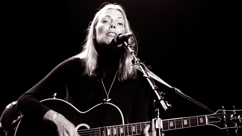 Joni Mitchell plays guitar