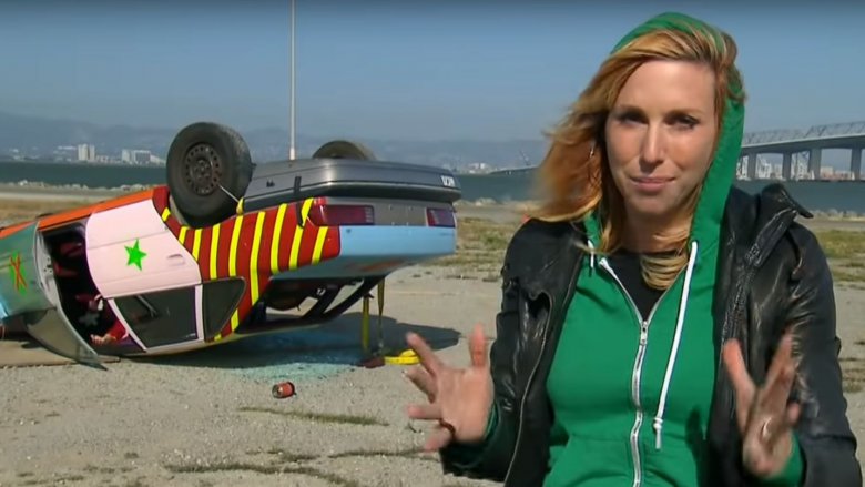 Kari Byron in front of  crashed car