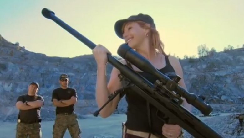 Kari Byron holding large gun with scope