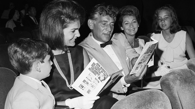 Leonard Bernstein sitting in the theater with Jackie Kennedy