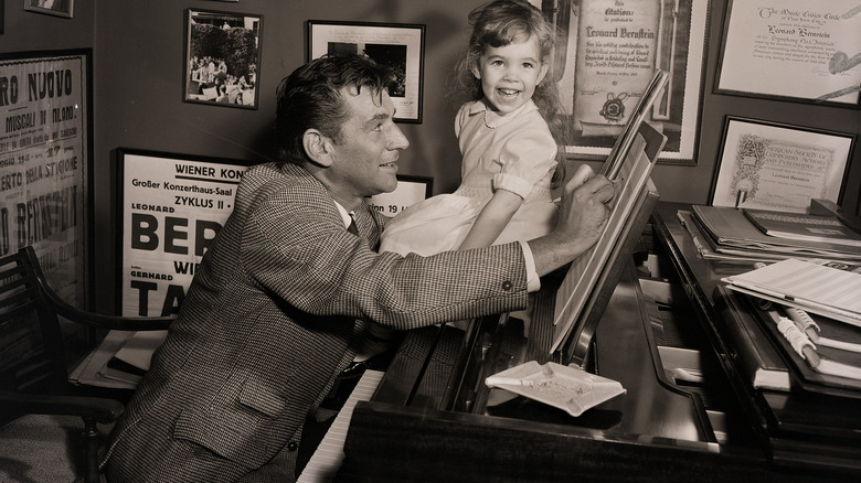 Leonard and Jamie Bernstein smiling with a piano