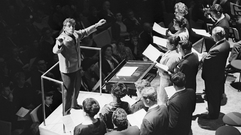 Leonard Bernstein conducting singers arms raised