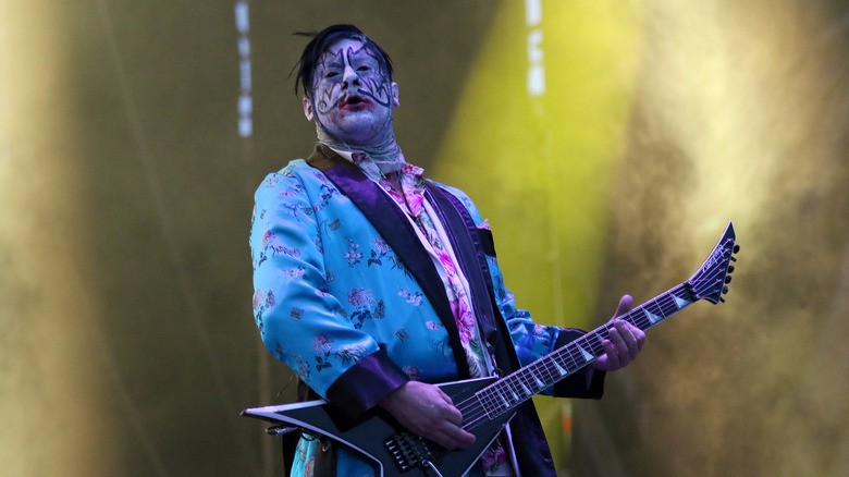 Wes Borland playing guitar face paint