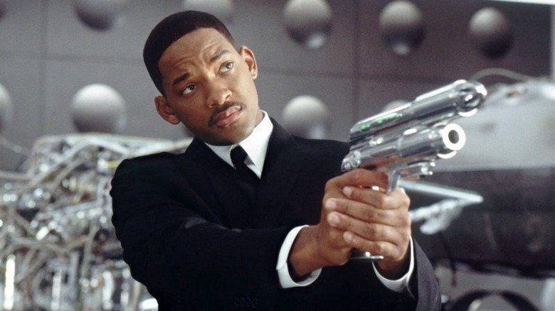 Will Smith black suit holding silver gun